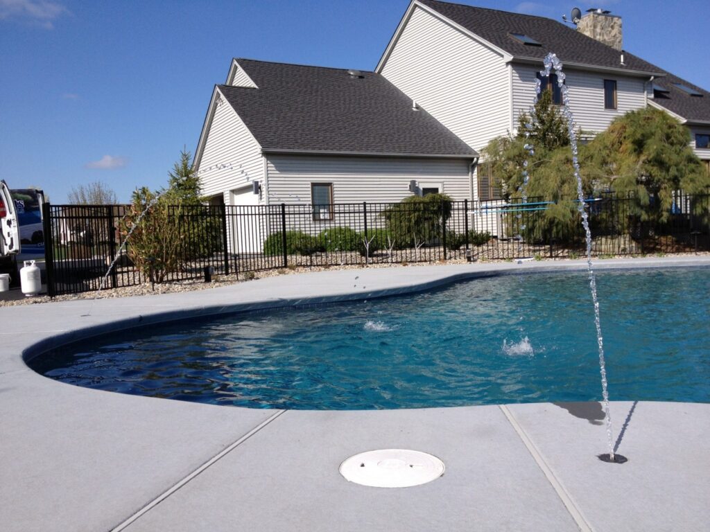 A Lehigh Valley custom-pool with fountains pouring into the pool from the side.